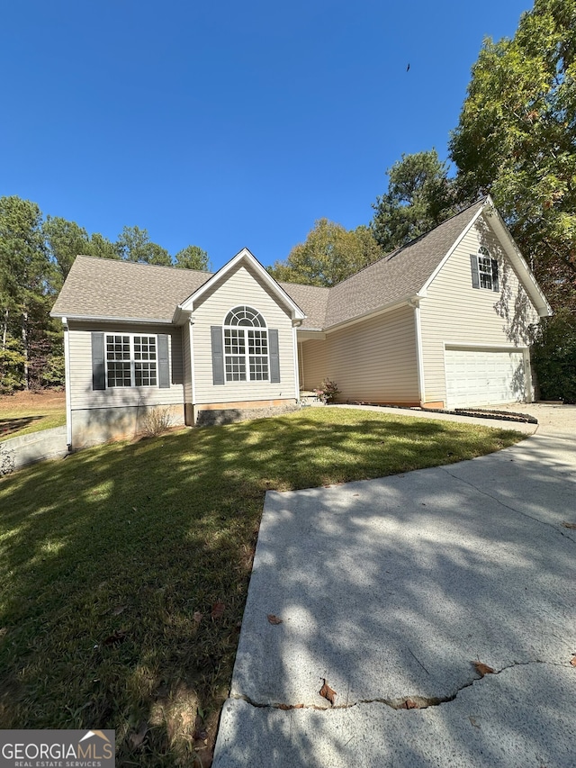 view of front facade with a front lawn and a garage