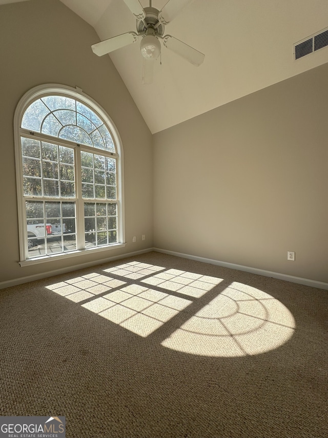 carpeted empty room featuring ceiling fan and high vaulted ceiling