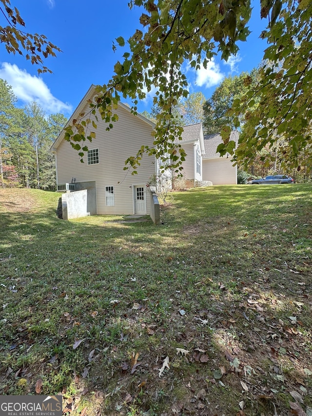 view of side of property with a lawn