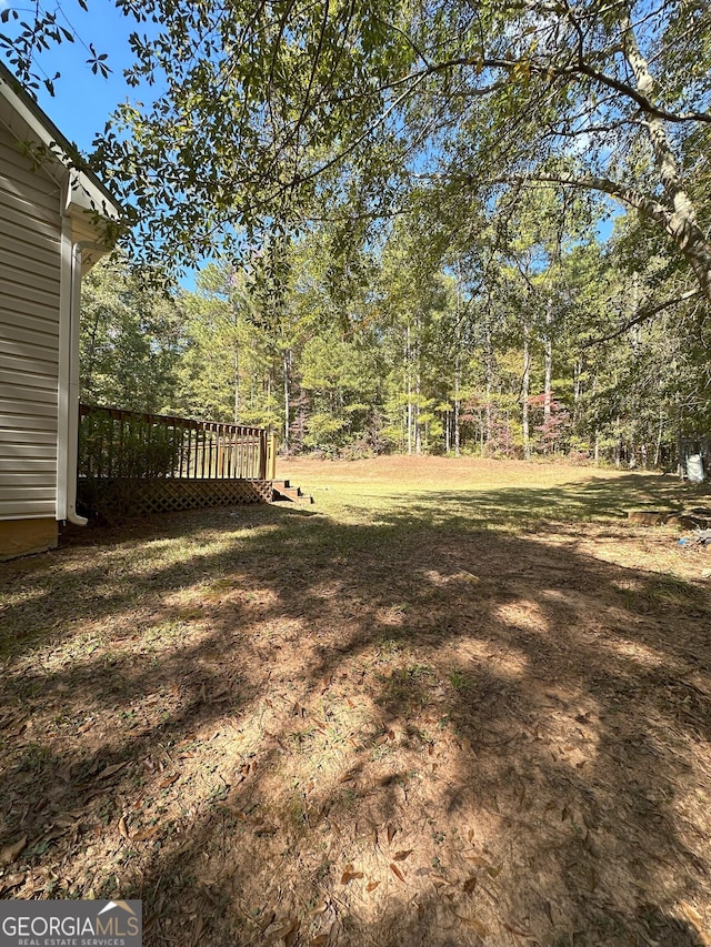 view of yard with a wooden deck