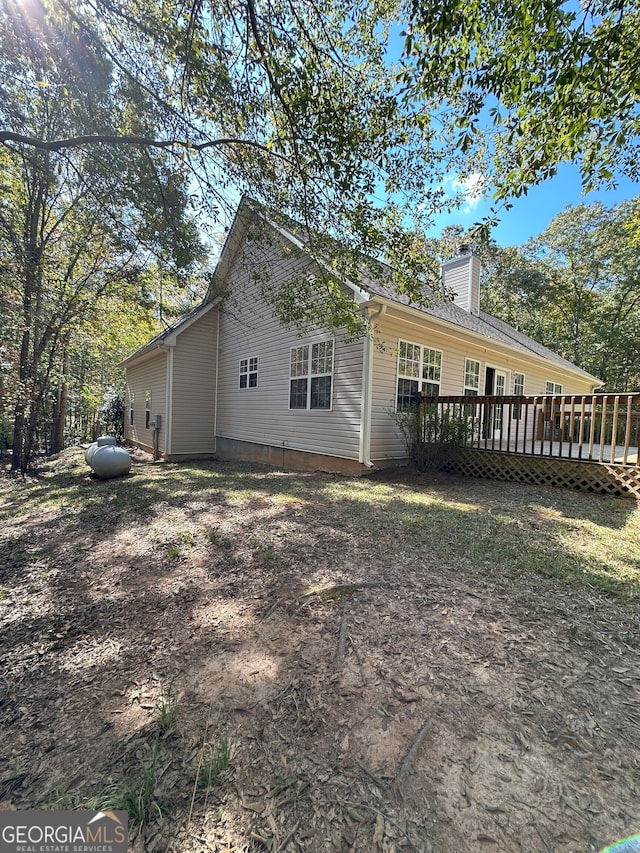 back of property with a wooden deck