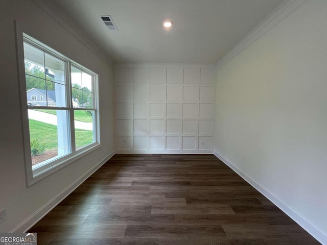 empty room featuring crown molding and dark wood-type flooring