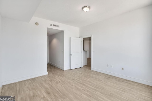 unfurnished room featuring light hardwood / wood-style flooring