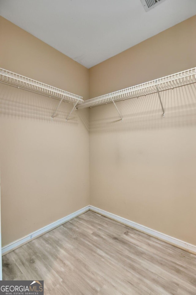 walk in closet featuring hardwood / wood-style flooring