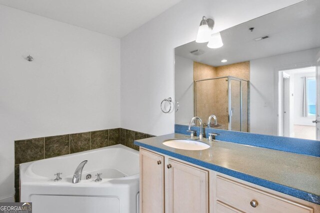 bathroom featuring vanity and shower with separate bathtub