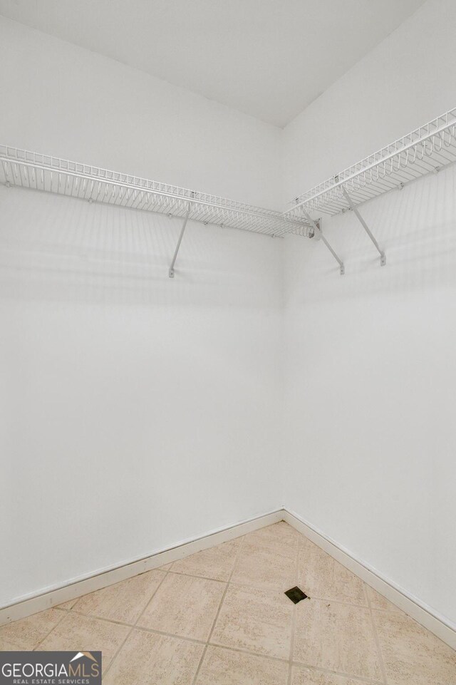 spacious closet with tile patterned flooring