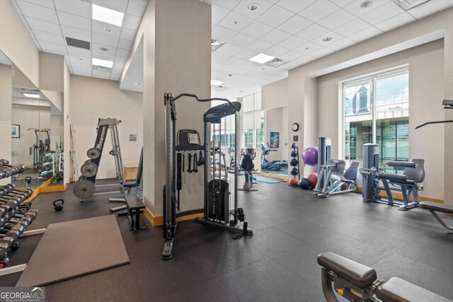 gym with a paneled ceiling