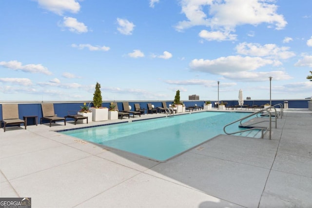 view of swimming pool featuring a patio area