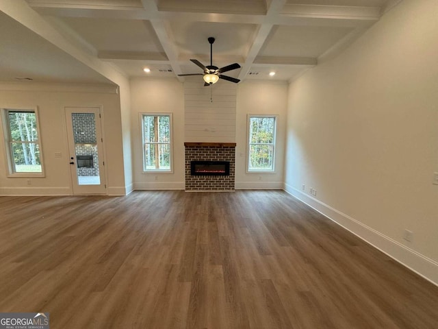 unfurnished living room featuring a fireplace, hardwood / wood-style floors, a wealth of natural light, and ceiling fan