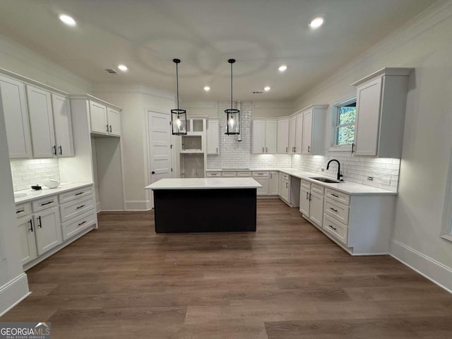 kitchen featuring white cabinetry, a kitchen island, dark wood-type flooring, and decorative light fixtures