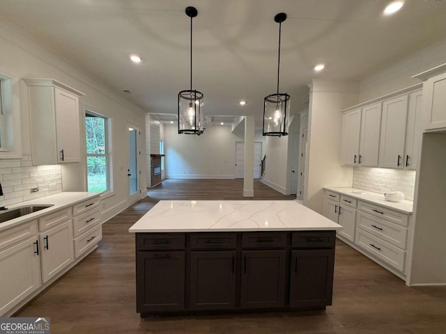 kitchen with white cabinetry, hanging light fixtures, and dark hardwood / wood-style floors