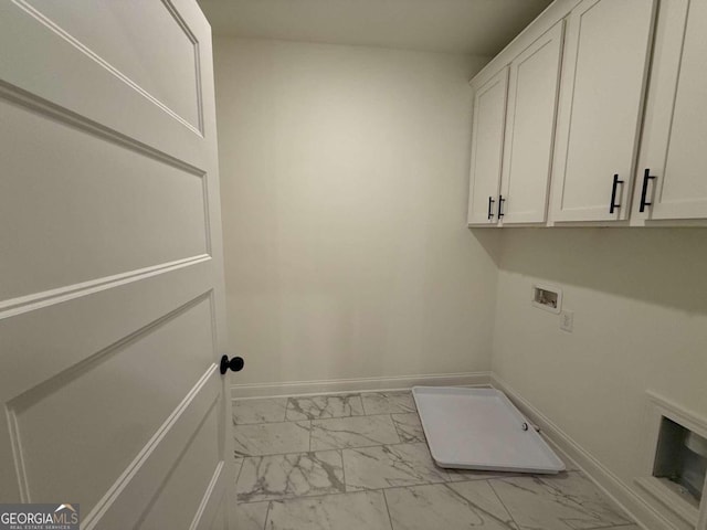 laundry room featuring washer hookup and cabinets