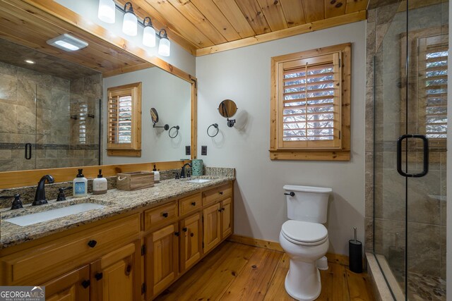 bathroom with an enclosed shower, vanity, hardwood / wood-style flooring, wooden ceiling, and toilet