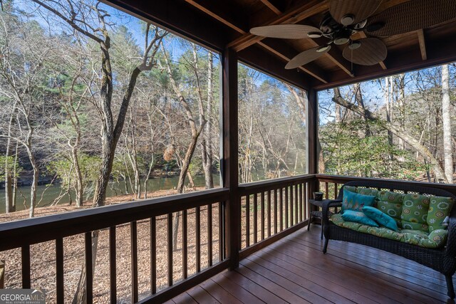 deck with ceiling fan, a water view, and an outdoor hangout area