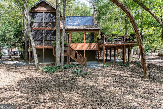 rear view of house with a wooden deck