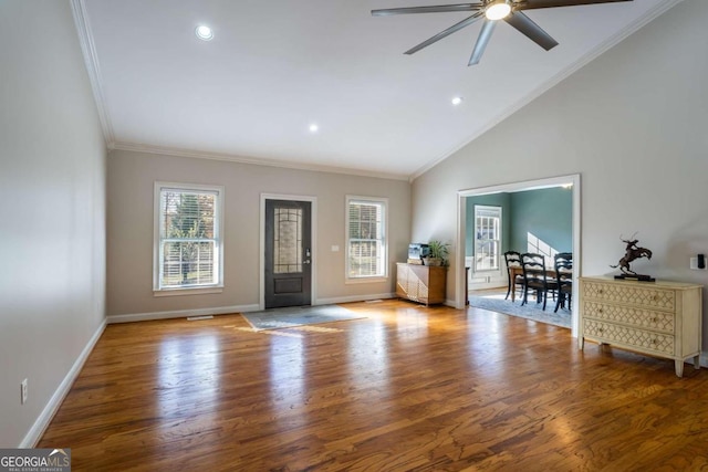 foyer entrance with crown molding, a healthy amount of sunlight, and hardwood / wood-style flooring