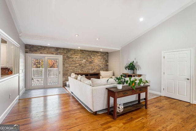 living room with a fireplace, light hardwood / wood-style flooring, and crown molding