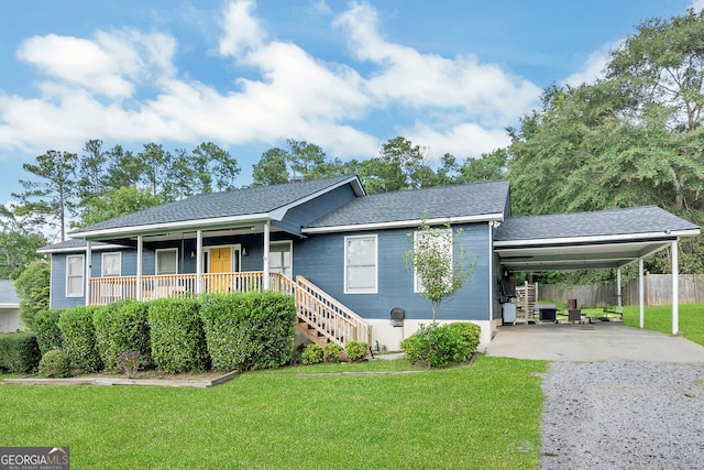 view of front of home with covered porch, a front lawn, and a carport