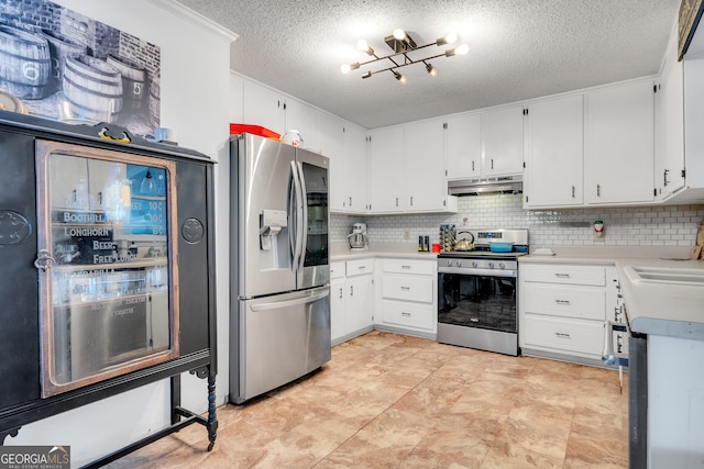 kitchen with decorative backsplash, white cabinetry, a textured ceiling, and appliances with stainless steel finishes