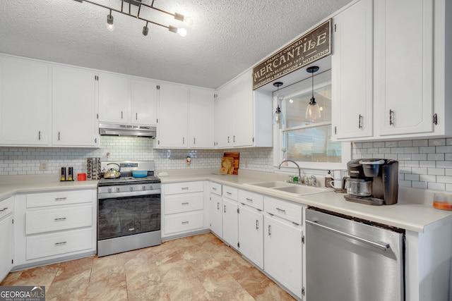 kitchen with sink, white cabinetry, stainless steel appliances, and tasteful backsplash