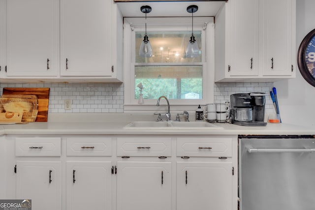 kitchen with white cabinetry, sink, hanging light fixtures, stainless steel dishwasher, and backsplash