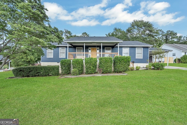 ranch-style home featuring a front lawn and covered porch