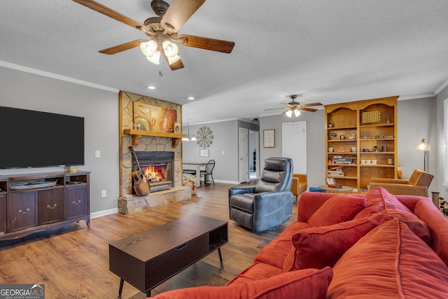 living room featuring wood-type flooring, a textured ceiling, and ceiling fan