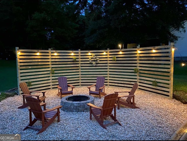 patio at twilight with an outdoor fire pit