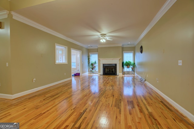 unfurnished living room with light wood-type flooring, ceiling fan, and crown molding