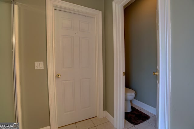 bathroom featuring tile patterned flooring and toilet