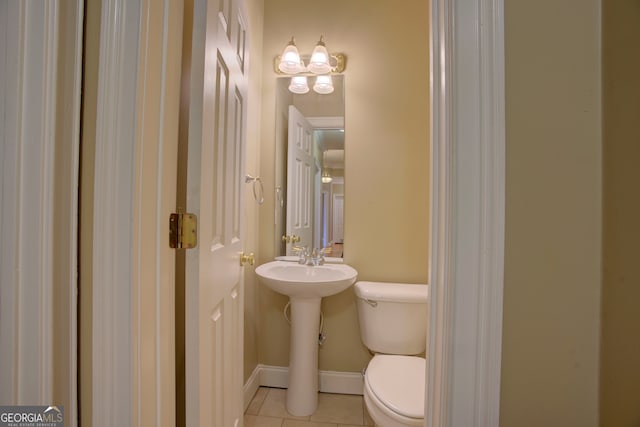 bathroom featuring tile patterned flooring and toilet