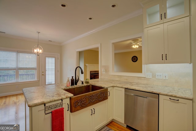 kitchen with sink, stainless steel dishwasher, kitchen peninsula, decorative backsplash, and light wood-type flooring