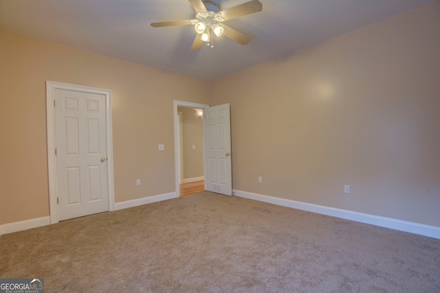 unfurnished bedroom featuring light colored carpet and ceiling fan