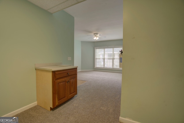 hallway featuring light colored carpet