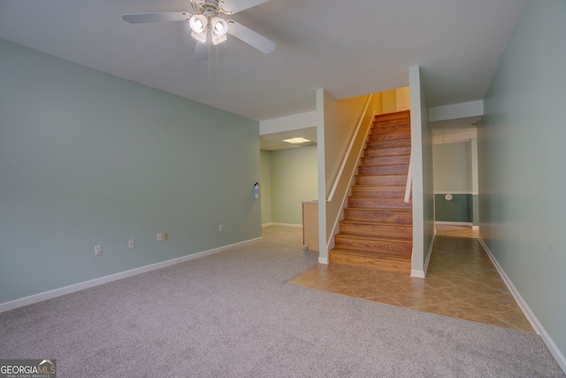 stairway with carpet and ceiling fan