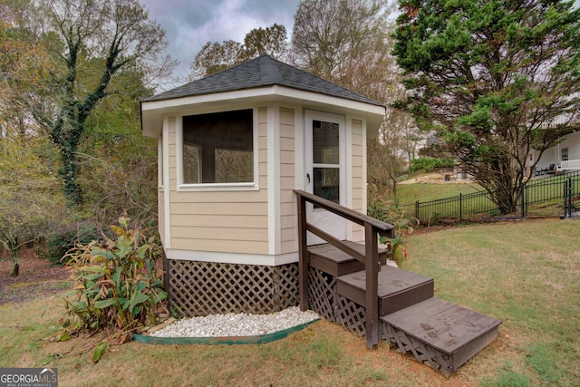 view of outdoor structure featuring a lawn