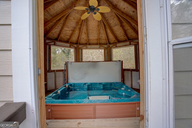 exterior space featuring ceiling fan, lofted ceiling, and a jacuzzi