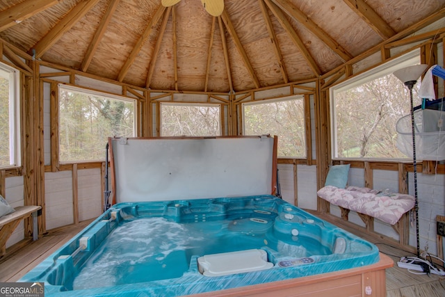 sunroom featuring a jacuzzi and lofted ceiling