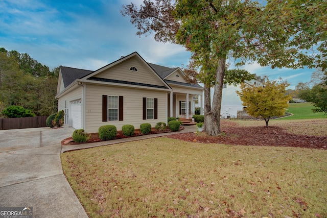 view of front of home with a front yard and a garage