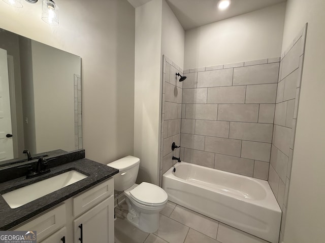 full bathroom featuring toilet, vanity, tiled shower / bath combo, and tile patterned floors