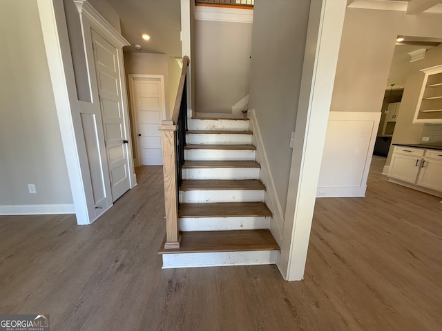 stairway with hardwood / wood-style floors