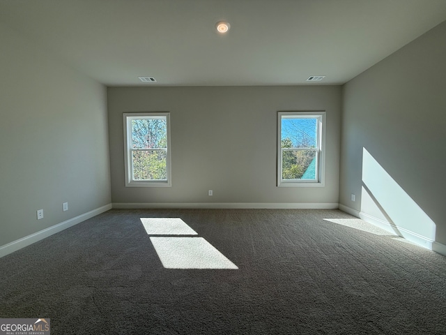 empty room featuring dark colored carpet