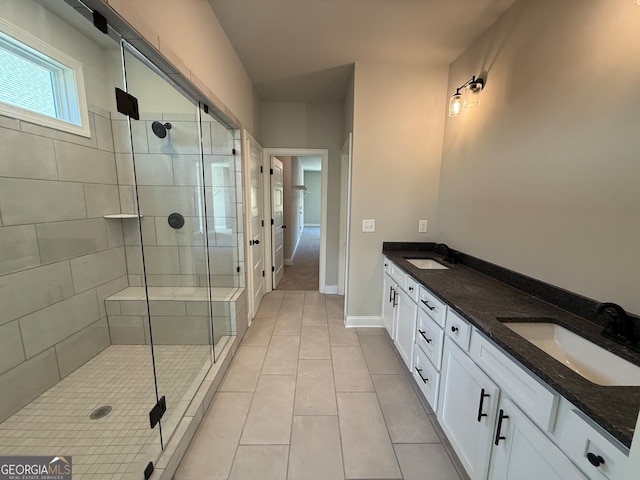 bathroom with vanity, tile patterned floors, and a shower with door