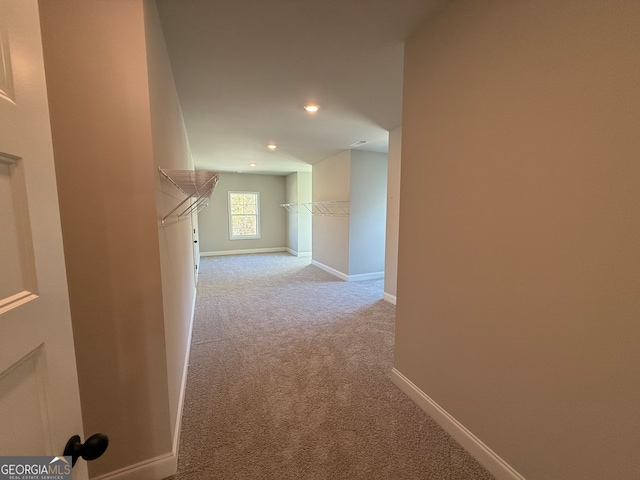 hallway with light colored carpet