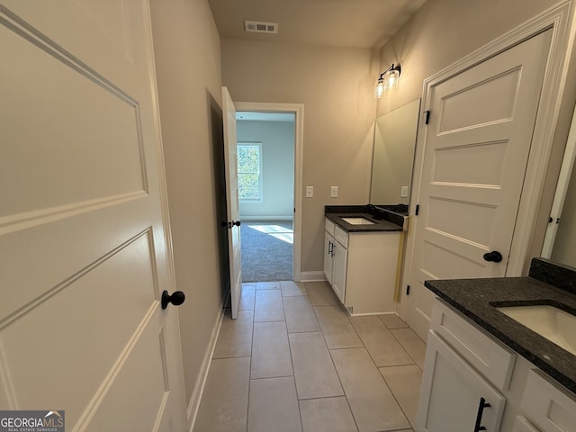 bathroom featuring tile patterned flooring and vanity