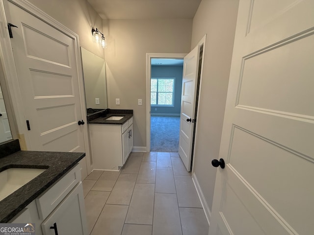 bathroom featuring tile patterned flooring and vanity