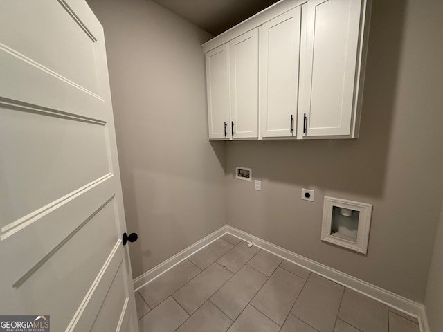 clothes washing area with washer hookup, electric dryer hookup, light tile patterned flooring, and cabinets