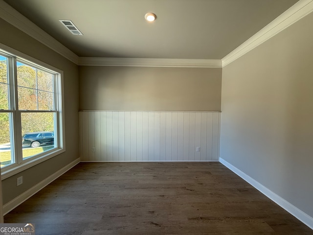 spare room featuring crown molding and dark wood-type flooring