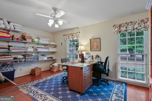 office area featuring a textured ceiling, dark hardwood / wood-style floors, and ceiling fan