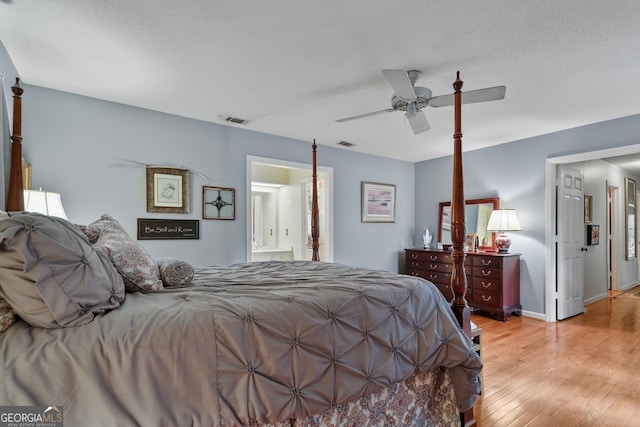 bedroom featuring connected bathroom, ceiling fan, light hardwood / wood-style flooring, and a textured ceiling